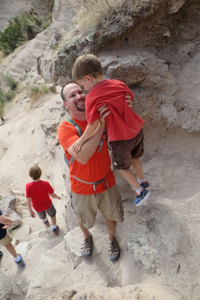 Helping our child down a steep part at Kasha Katuwe Tent Rock, New Mexico - An Epic Slot-Canyon Hike