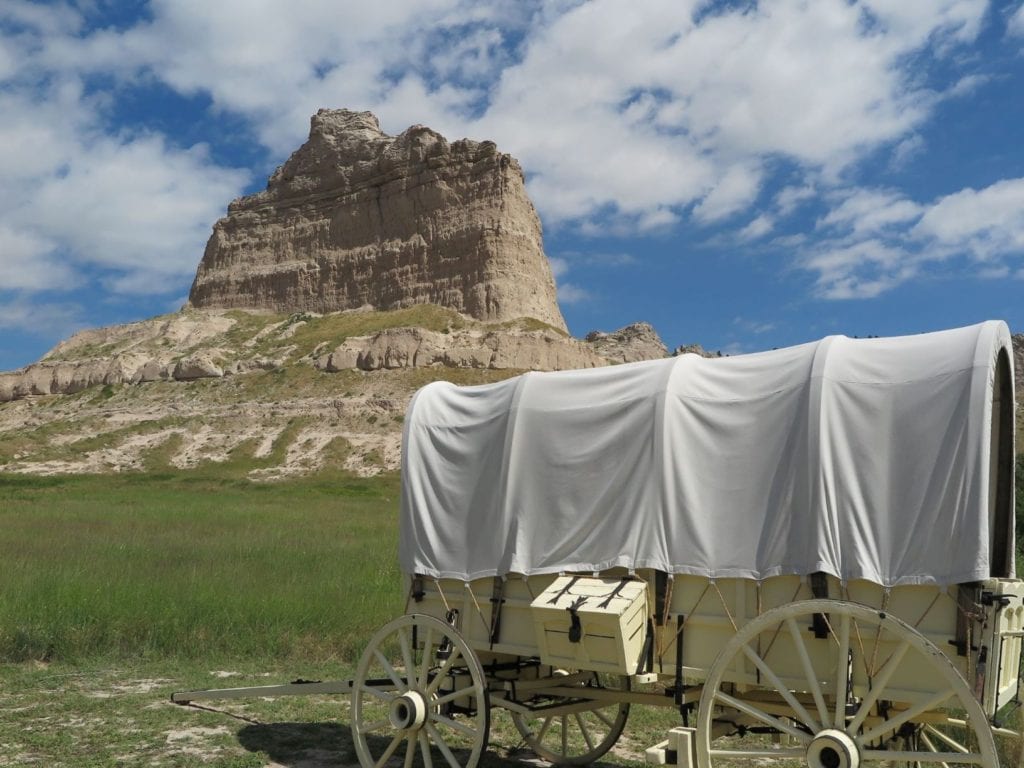 Scotts Bluff, Nebraska Picturesque view with a covered wagon in front of the bluff