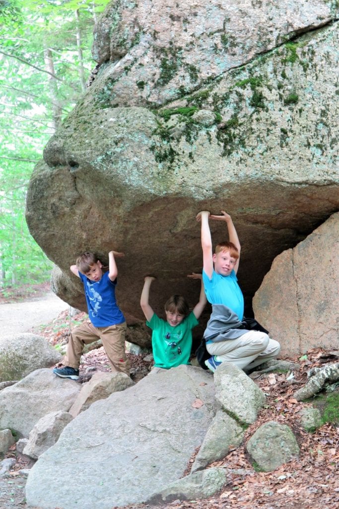 Flume Gorge- fun family pictures, holding a rock up, Franconia Notch, New Hampshire