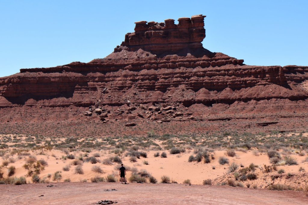Valley of the Gods, Utah with a man looking up at these gorgeous red rock formations